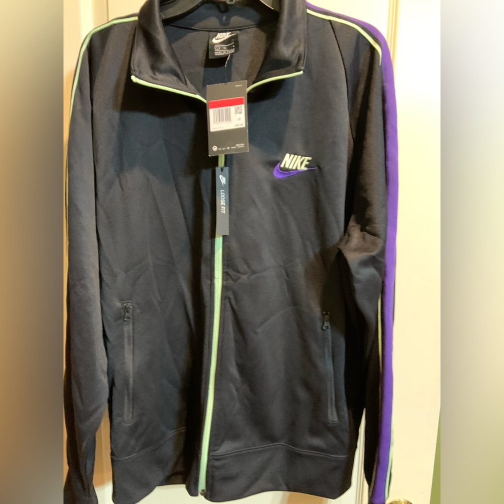 Nike- Men’s jacket   Black with stripe down arm sleeve.  Large zipper front